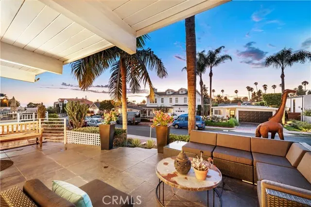 a living room with furniture and a wall painting