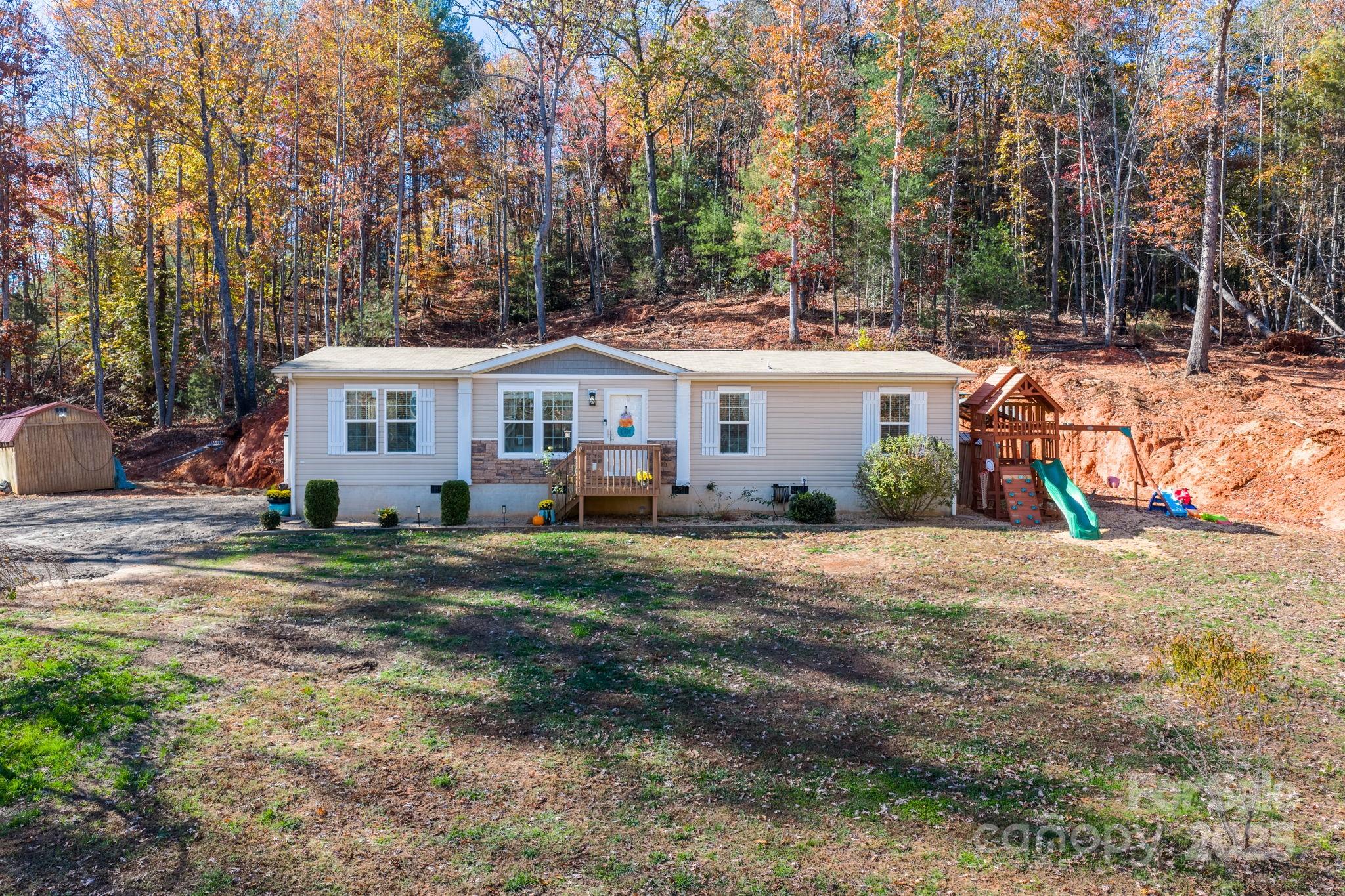 2603 Setzers Gap Road Lenoir, NC 28645 - Photo 1 of 29 a view of a house with yard and sitting area