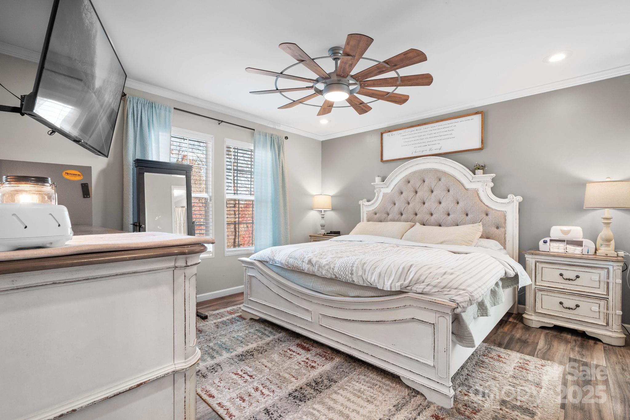 2603 Setzers Gap Road Lenoir, NC 28645 - Photo 13 of 29 a bedroom with a large bed and a chandelier