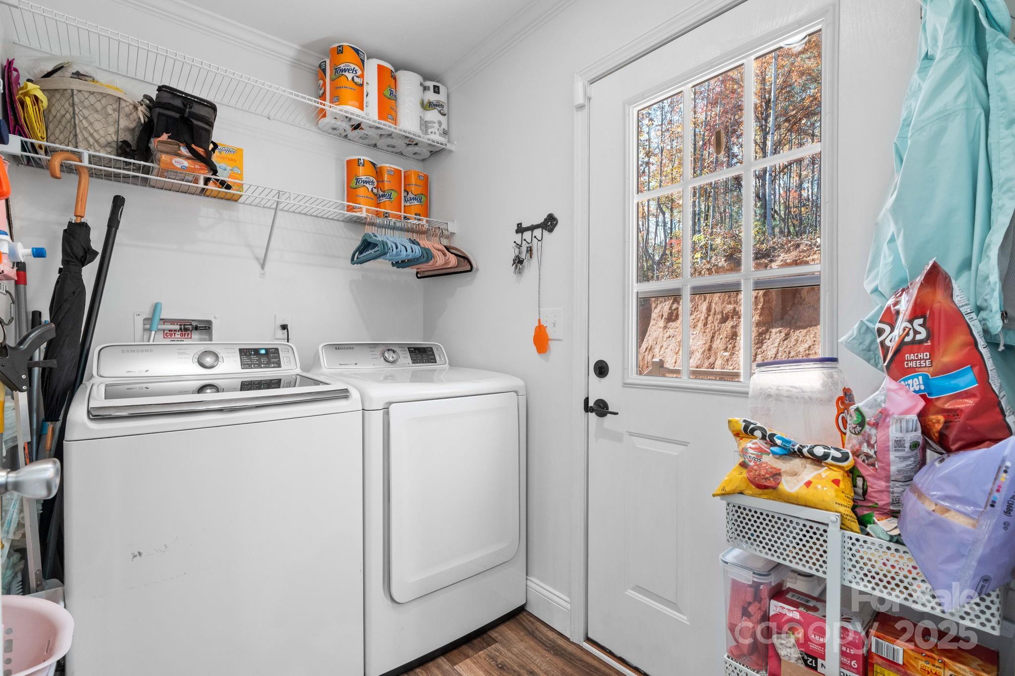 2603 Setzers Gap Road Lenoir, NC 28645 - Photo 19 of 29 a utility room with fridge dryer and baby