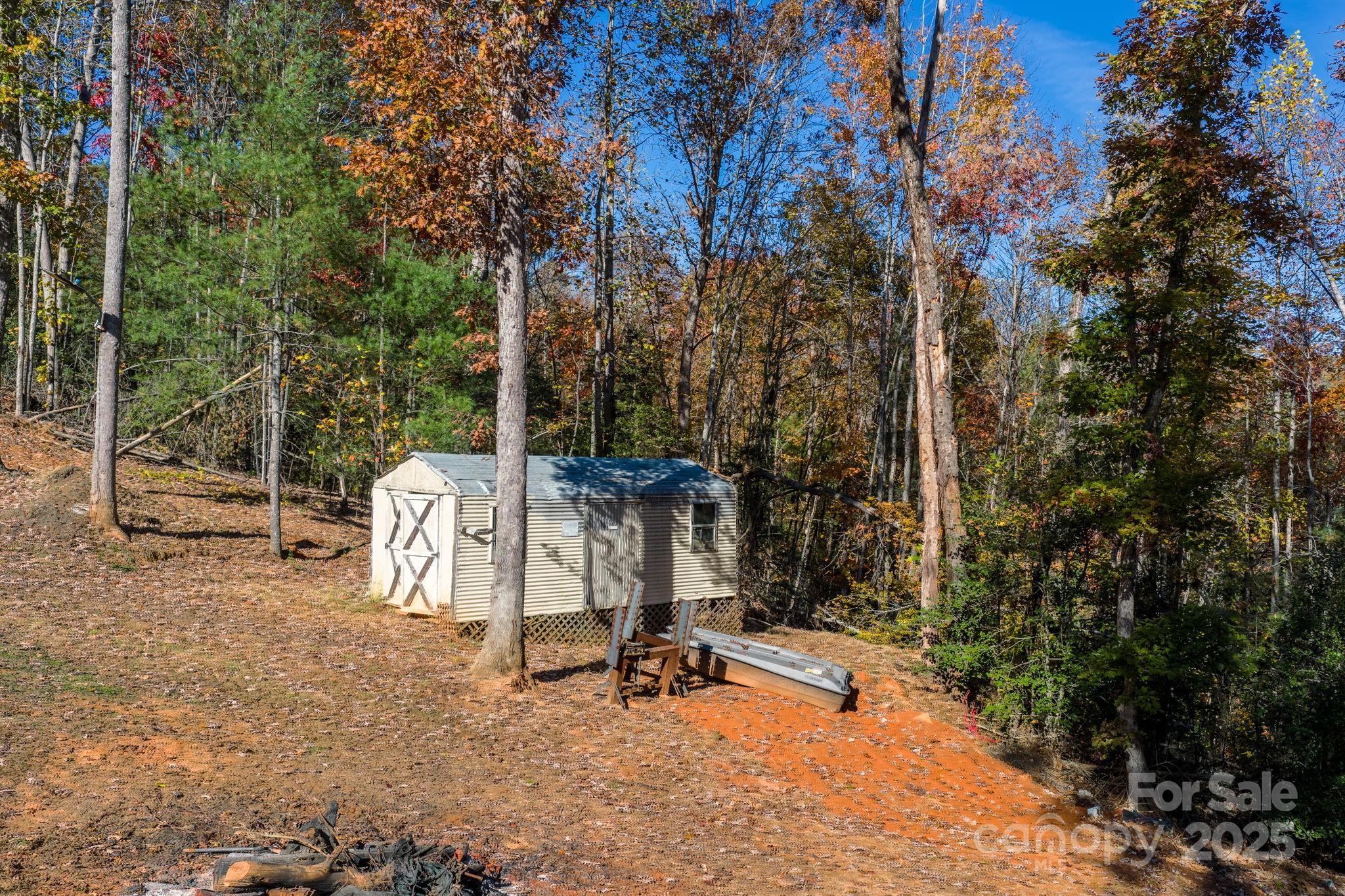 2603 Setzers Gap Road Lenoir, NC 28645 - Photo 21 of 29 a view of a chair and tables in the backyard