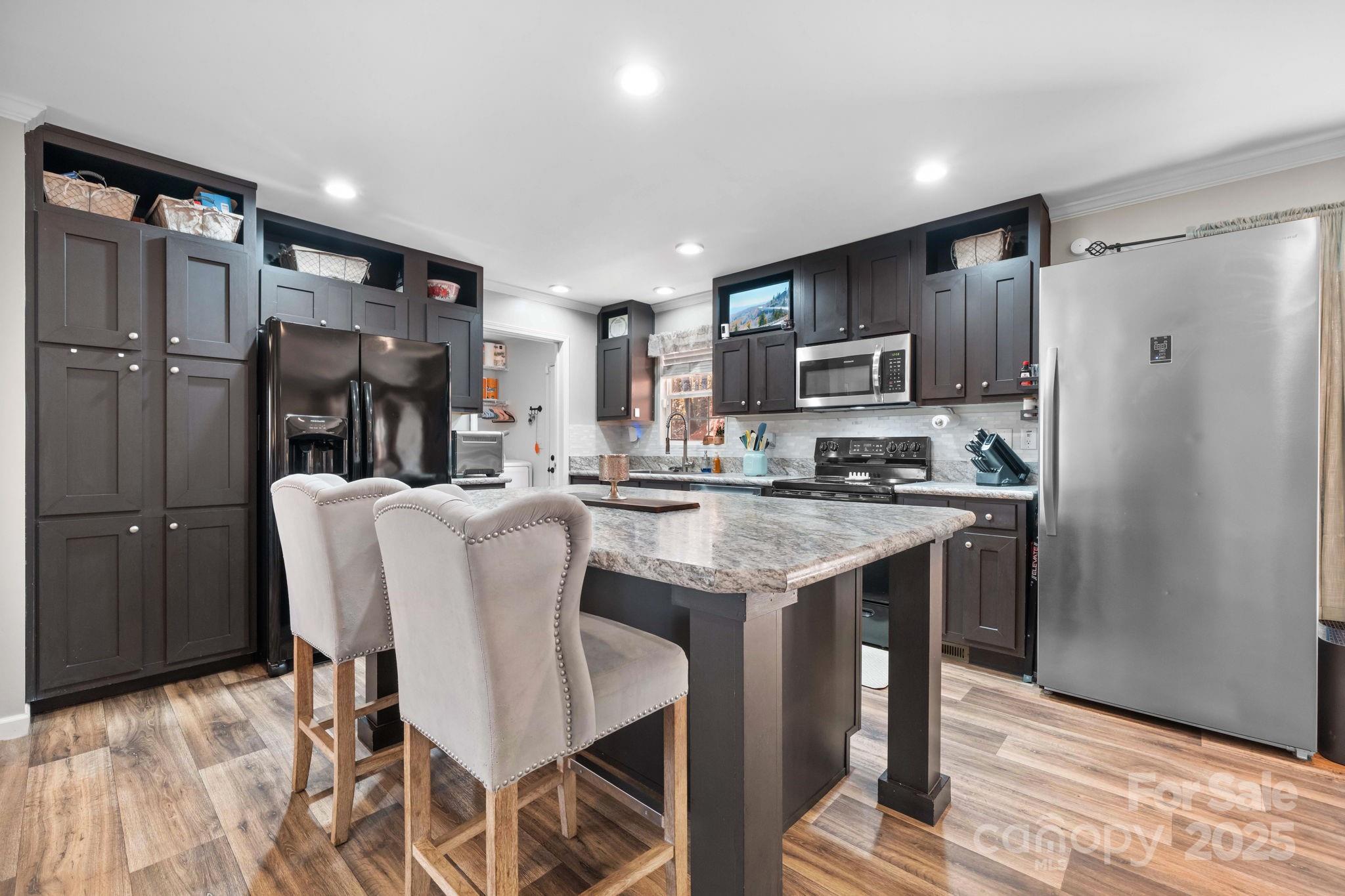 2603 Setzers Gap Road Lenoir, NC 28645 - Photo 7 of 29 a kitchen with stainless steel appliances granite countertop a refrigerator and a stove top oven