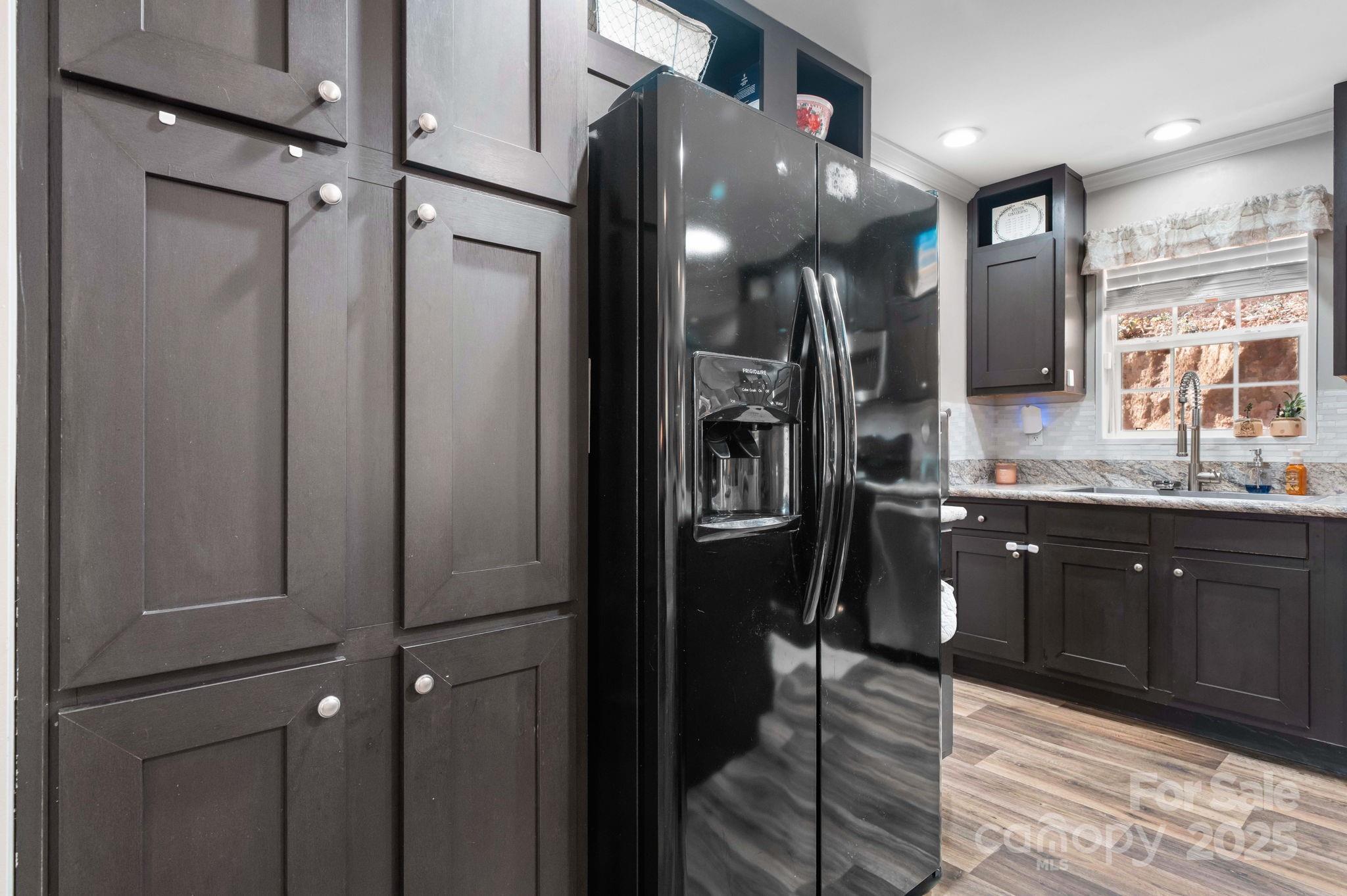 2603 Setzers Gap Road Lenoir, NC 28645 - Photo 8 of 29 a kitchen with stainless steel appliances granite countertop cabinets a sink and a refrigerator