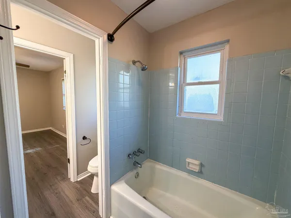 a bathroom with a tub and shower