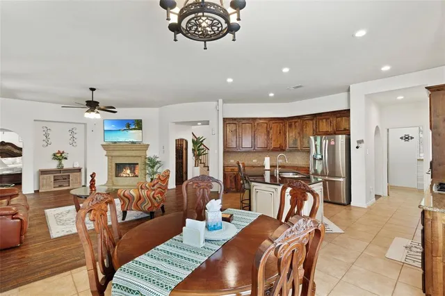 a living room with furniture a ceiling fan and a rug