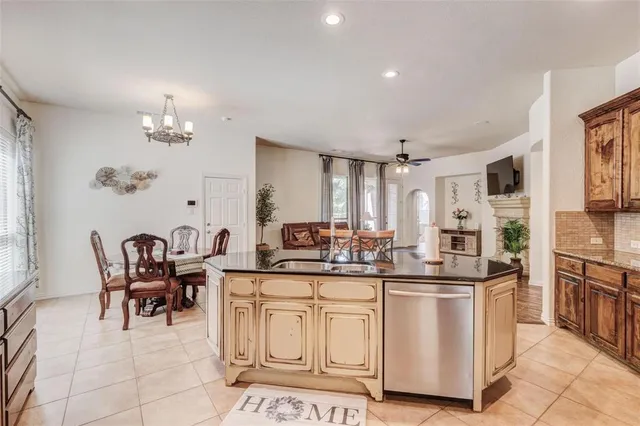 a kitchen with cabinets and chairs