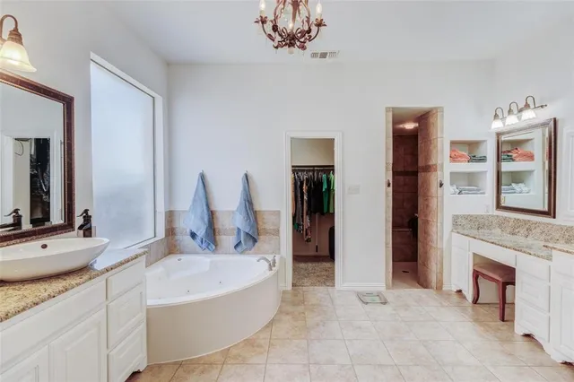 a bathroom with a tub sink and a mirror