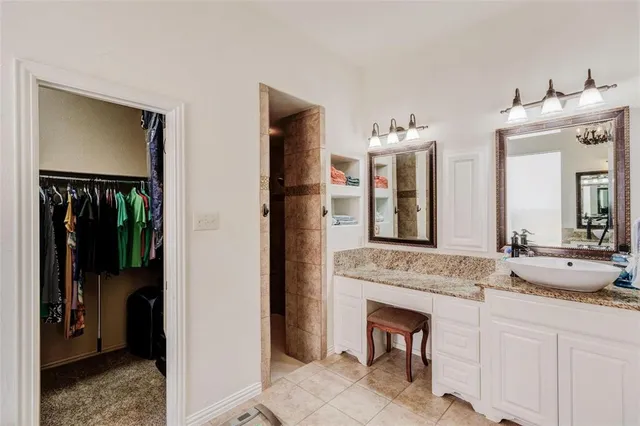 a en suite bathroom with a sink and a mirror