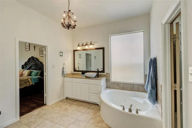 a bathroom with a tub sink and mirror