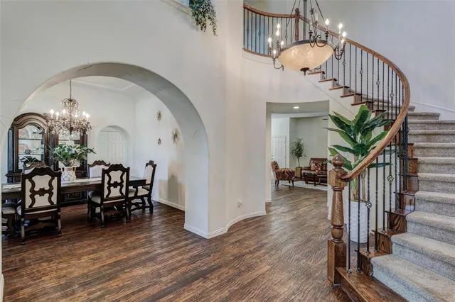 a view of a livingroom with wooden floor and furniture