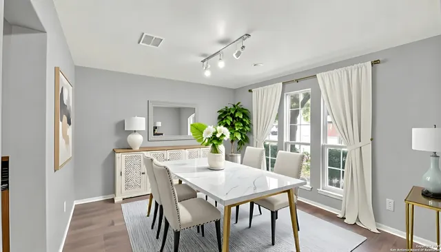a view of a dining room with furniture window and wooden floor