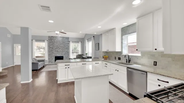 a kitchen with a sink stove and cabinets