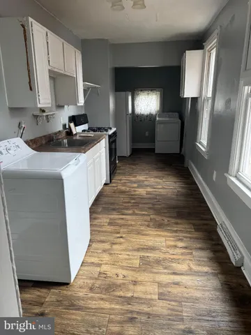 a kitchen with stainless steel appliances a refrigerator sink and stove
