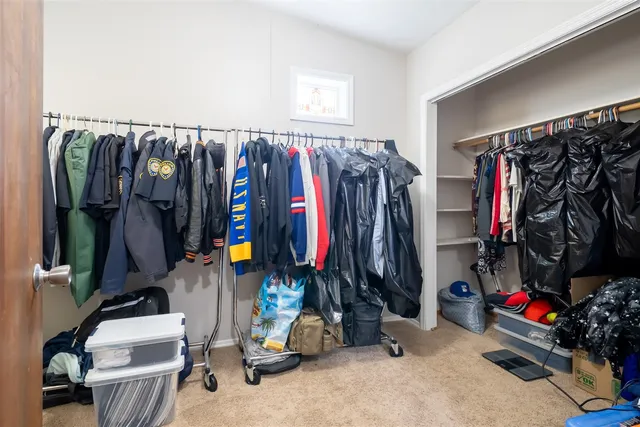 a view of walk in closet with clothes
