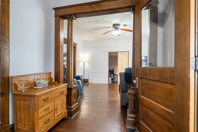 a view of a hallway with workspace and mirror