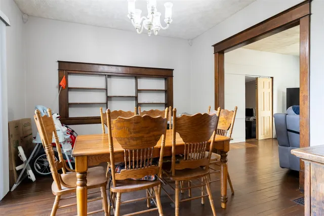 a dining room with furniture and wooden floor