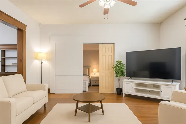 a living room with furniture and a flat screen tv