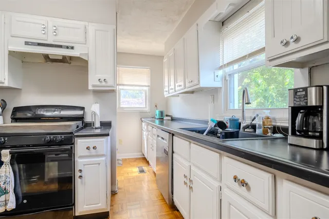 a kitchen with stainless steel appliances a stove sink and cabinets