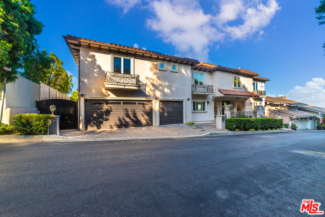 1236 Stradella Road Los Angeles, CA 90077 - Photo 2 of 26 a front view of a house with a yard