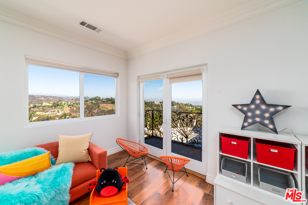 1236 Stradella Road Los Angeles, CA 90077 - Photo 17 of 26 a bed room with furniture and a window