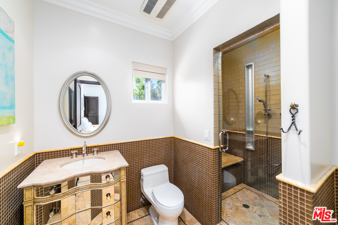1236 Stradella Road Los Angeles, CA 90077 - Photo 18 of 26 a bathroom with a toilet a sink and mirror