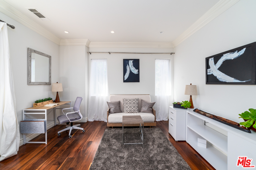 1236 Stradella Road Los Angeles, CA 90077 - Photo 20 of 26 a living room with furniture and wooden floor