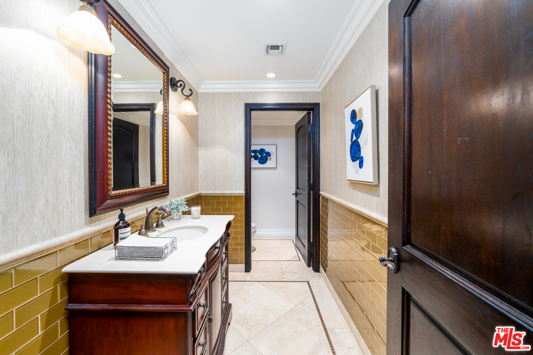 1236 Stradella Road Los Angeles, CA 90077 - Photo 10 of 26 a bathroom with a sink a mirror and a shower
