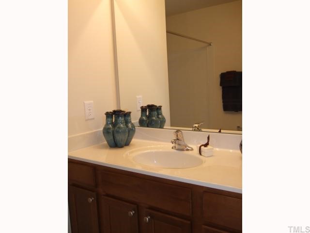 2904 Casona Way Raleigh, NC 27616 - Photo 8 of 12 a bathroom with a sink and a mirror