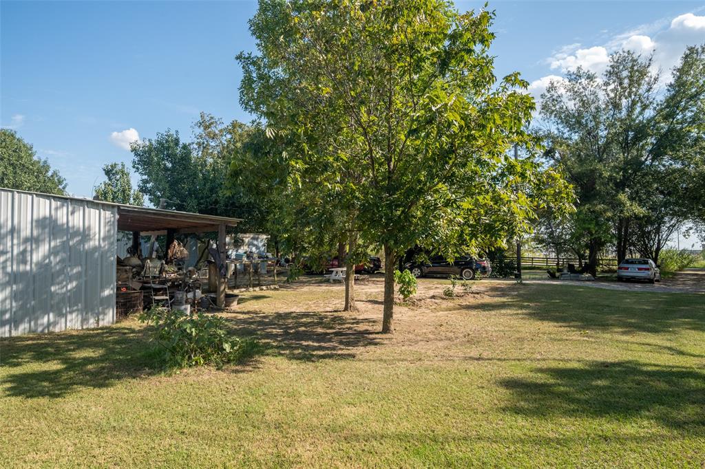 814 Signal Road Quinlan, TX 75474 - Photo 9 of 20 a view of a yard with plants and trees