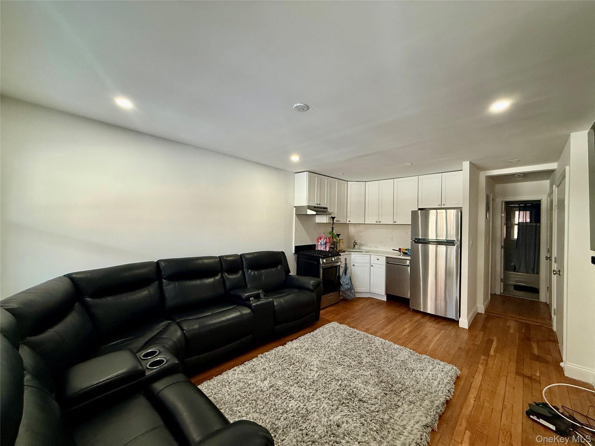 765 Shore Road, Unit 1N Long Beach, NY 11561 - Photo 2 of 13 a living room with furniture and a rug