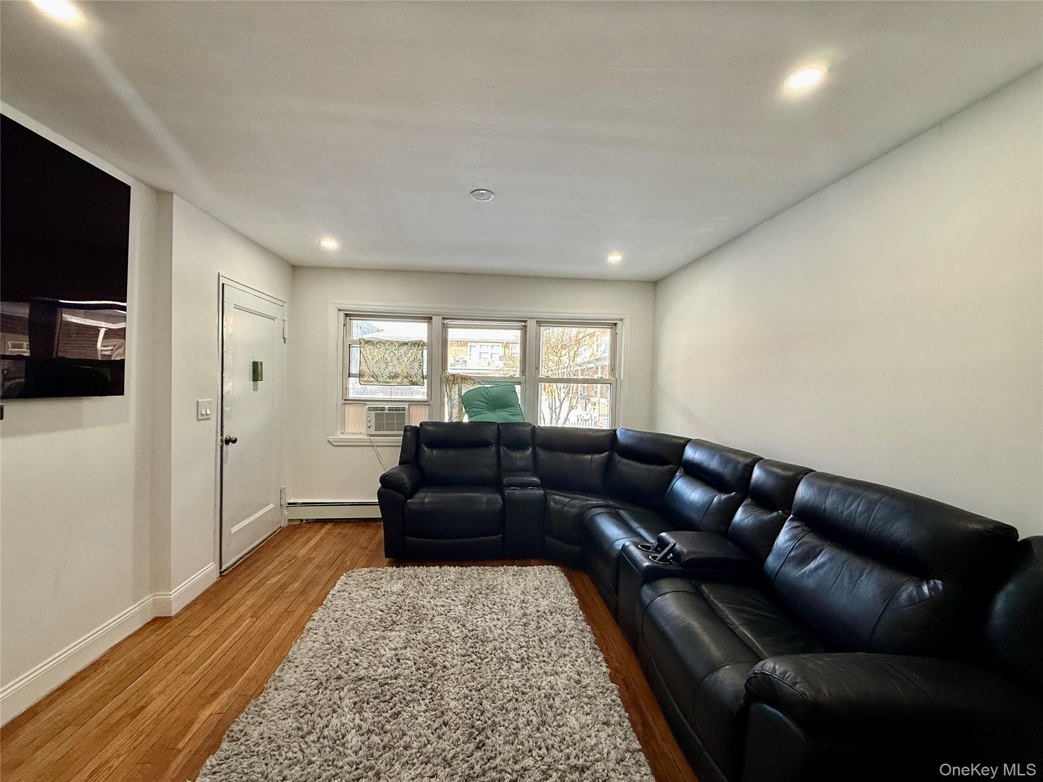 765 Shore Road, Unit 1N Long Beach, NY 11561 - Photo 4 of 13 a living room with furniture and a rug