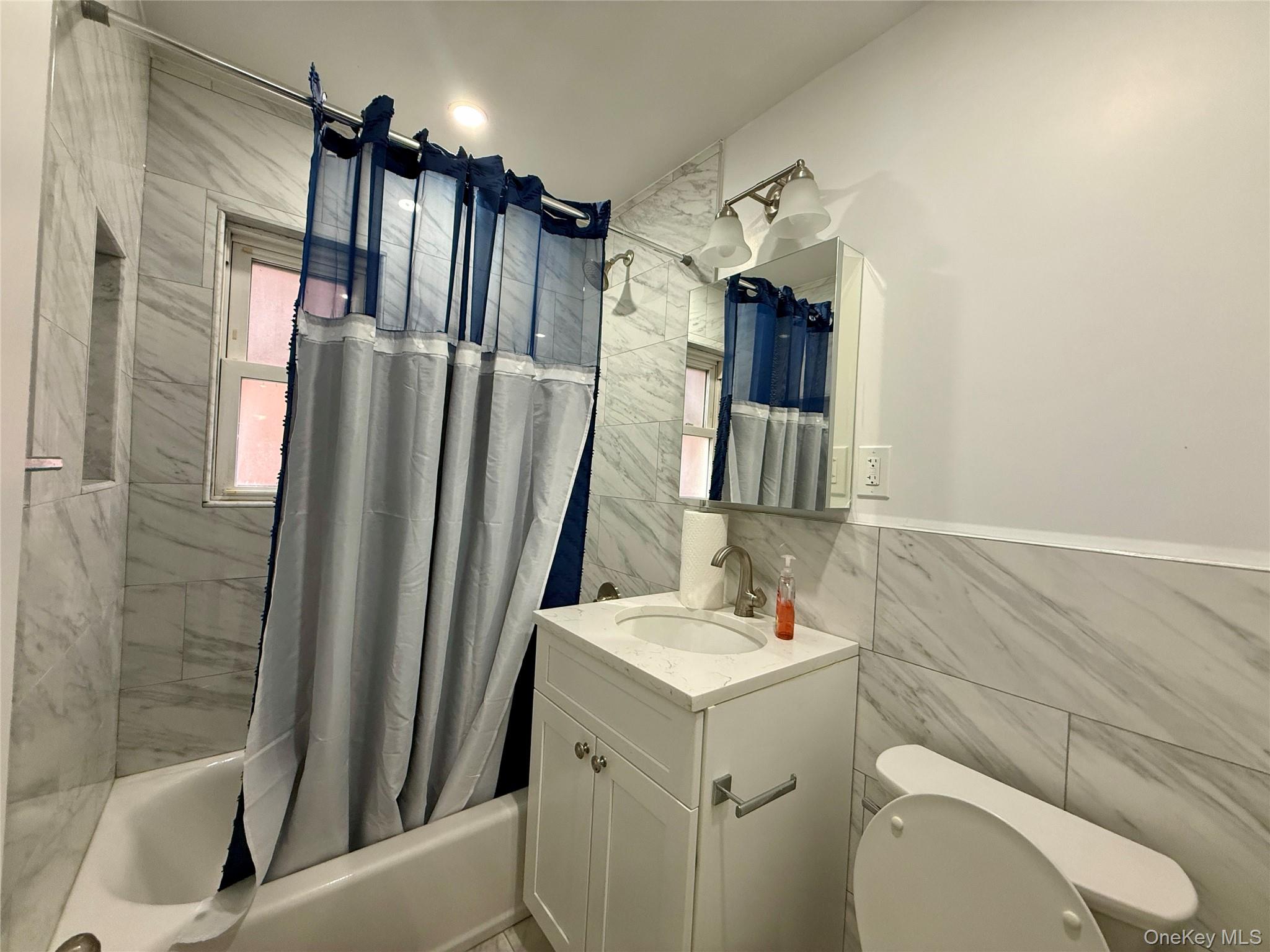 765 Shore Road, Unit 1N Long Beach, NY 11561 - Photo 8 of 13 a bathroom with a sink toilet and shower