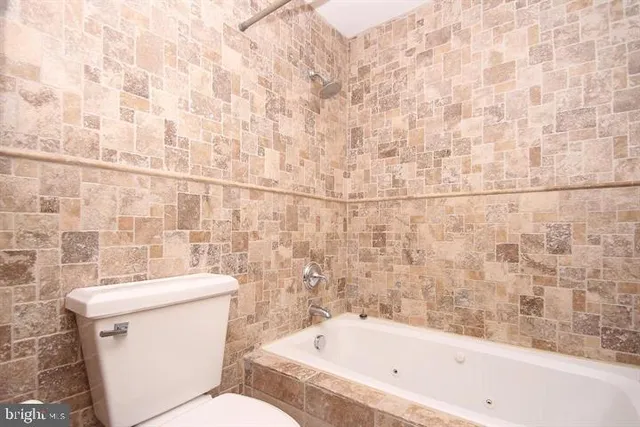 a bathroom with a bathtub and toilet
