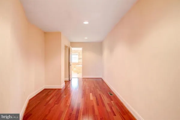 a view of a room with wooden floor and brick walls
