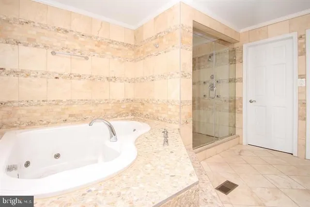 a bathroom with a bathtub and shower