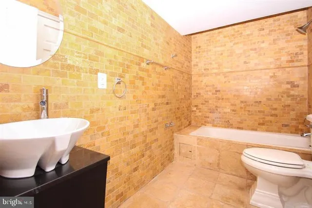 a bathroom with a toilet a sink and bathtub