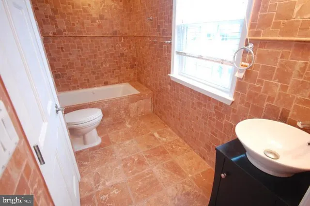 a bathroom with a toilet a sink and a shower