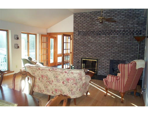 60 Warren Road Brimfield, MA 01010 - Photo 4 of 6 a living room with furniture a large window and a fireplace