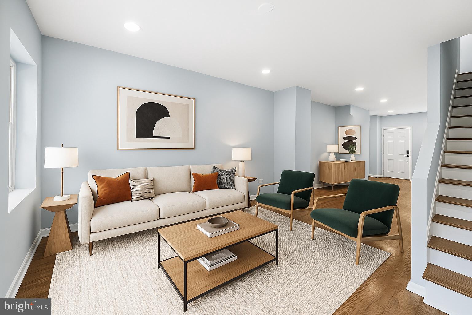 a living room with furniture and a wooden floor