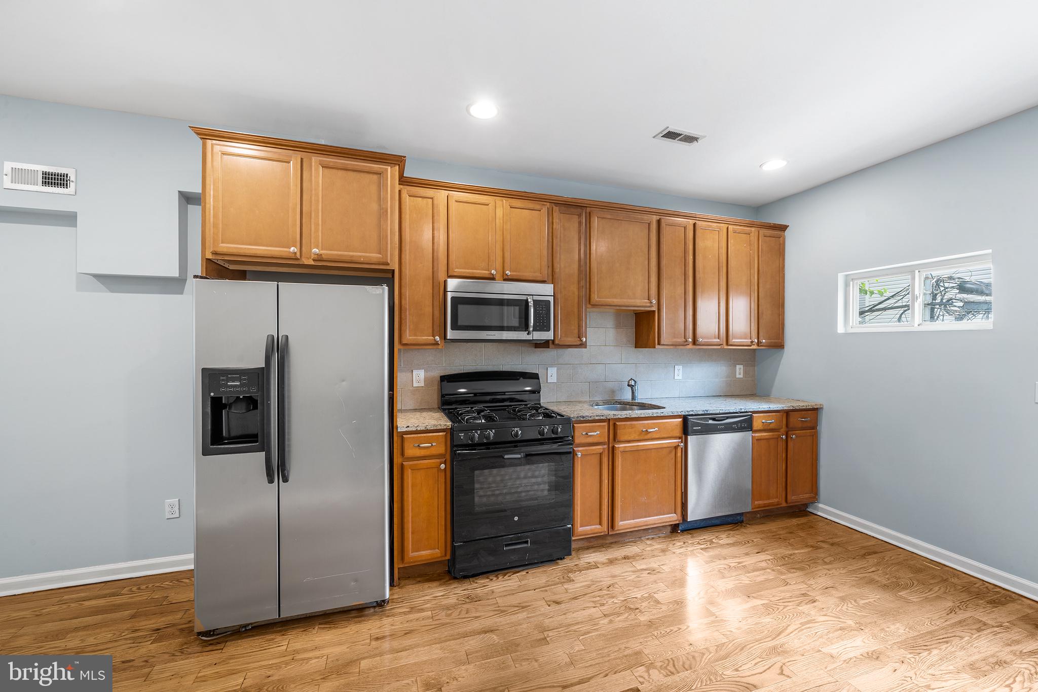 1904 Manton Street Philadelphia, PA 19146 - Photo 11 of 31 a kitchen with stainless steel appliances granite countertop a refrigerator stove top oven and sink