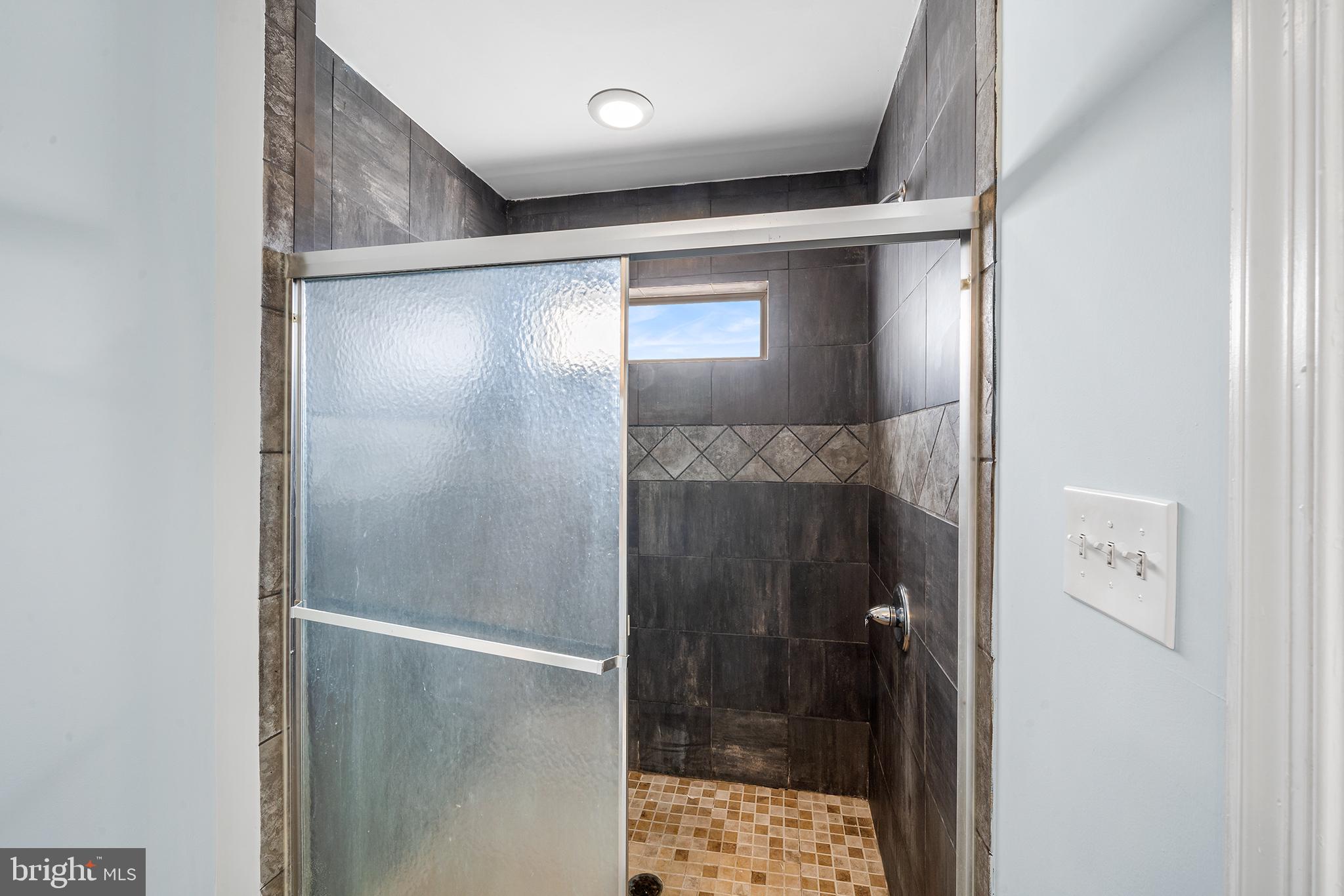 1904 Manton Street Philadelphia, PA 19146 - Photo 24 of 31 a bathroom with a glass shower door