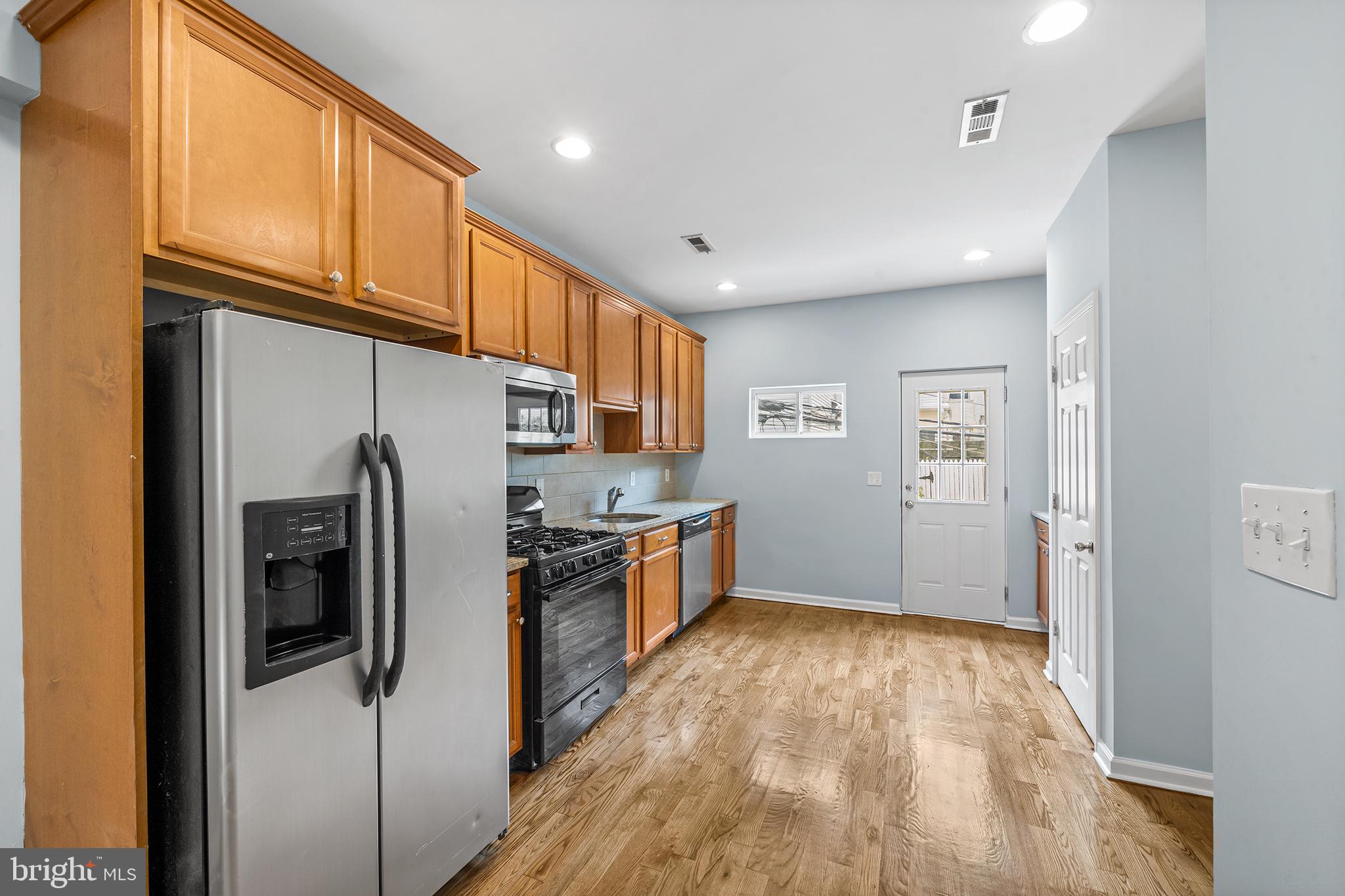1904 Manton Street Philadelphia, PA 19146 - Photo 3 of 31 a kitchen with stainless steel appliances granite countertop a refrigerator and a stove top oven