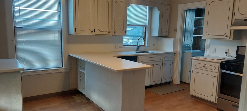 9 Oakview Terrace Boston, MA 02130 - Photo 2 of 9 a kitchen that has a sink and a stove