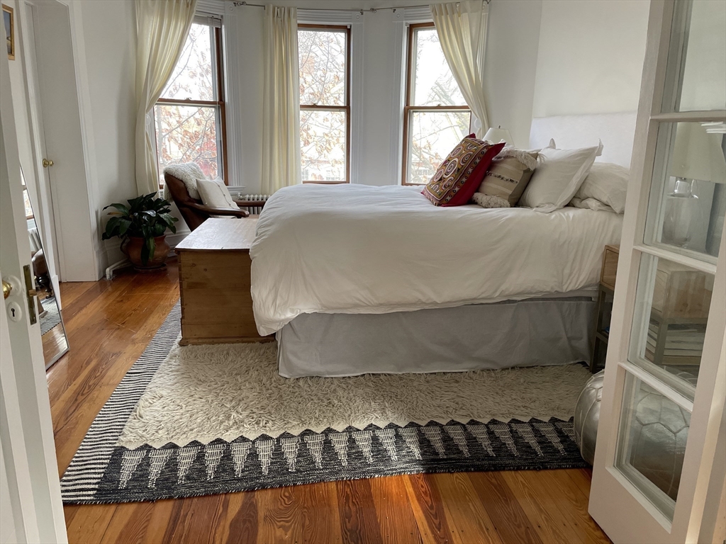 9 Oakview Terrace Boston, MA 02130 - Photo 3 of 9 a bedroom with a bed and wooden floor