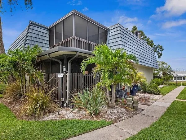 a view of a house with a yard and plants