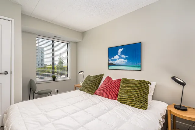 a bedroom with a bed and a window