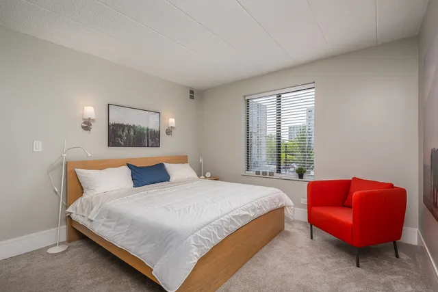 a bedroom with bed and a couch