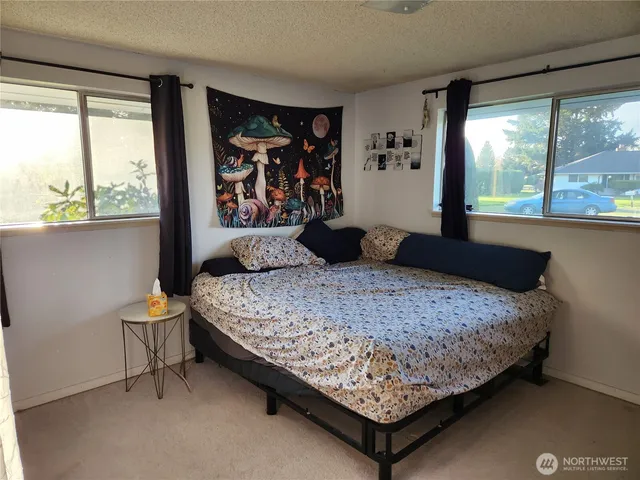 a bedroom with a bed and window