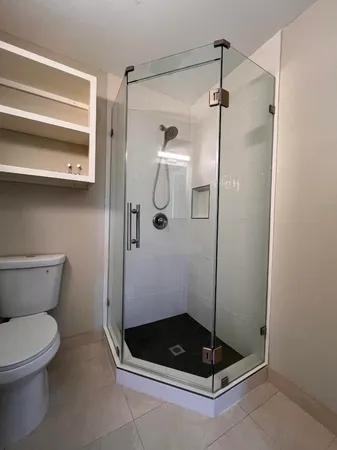 a bathroom with a toilet and a shower