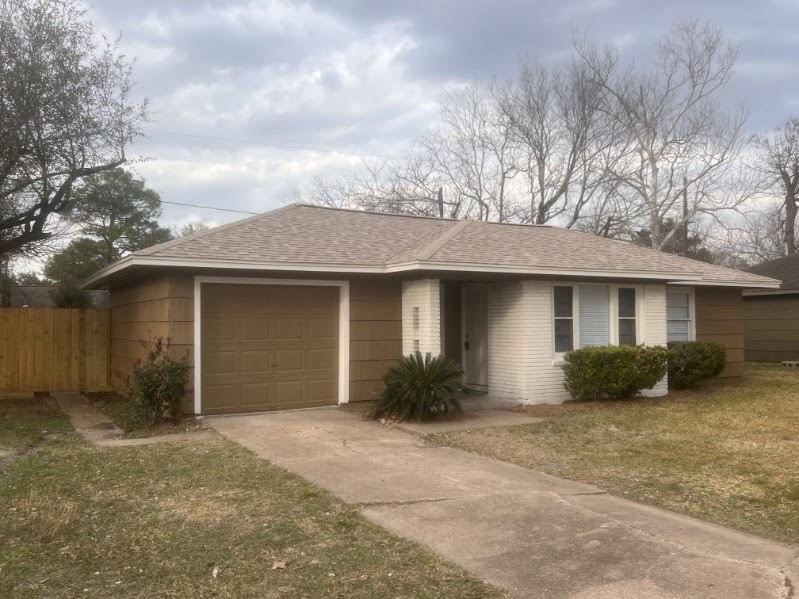 5834 Indigo Street Houston, TX 77074 - Photo 2 of 15 a front view of a house with a yard and garage